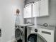 Laundry room features modern appliances and storage, offering convenience and style at 12955 Cats Claw Ln, Orlando, FL 32828