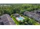 Aerial view of a community pool and clubhouse surrounded by lush landscaping and well-maintained townhomes at 12955 Cats Claw Ln, Orlando, FL 32828