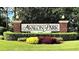 A decorative Avalon Park sign surrounded by a lush landscape with colorful flowerbeds at 12955 Cats Claw Ln, Orlando, FL 32828