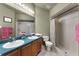 Bathroom features double sink vanity and shower with curtain at 13416 Greenpointe Dr, Orlando, FL 32824