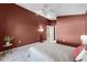 Bedroom with tan tile flooring, ceiling fan, and brown colored walls at 13416 Greenpointe Dr, Orlando, FL 32824