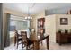 Dining room boasts a wood table set with chairs, adjacent to a window offering natural light at 13416 Greenpointe Dr, Orlando, FL 32824