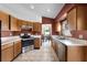 Well-equipped kitchen with stainless steel appliances, tile floors, and ample countertop space at 13416 Greenpointe Dr, Orlando, FL 32824
