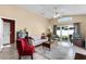Bright living room with comfortable seating, ceiling fan, and slider doors to the lanai at 13416 Greenpointe Dr, Orlando, FL 32824