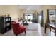 Open living area with tile flooring, vaulted ceilings, and sliding doors leading to outdoor space at 13416 Greenpointe Dr, Orlando, FL 32824