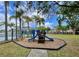 Community playground area with blue slide, palm trees, and lush greenery, perfect for Gathering fun at 13416 Greenpointe Dr, Orlando, FL 32824