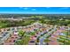 An aerial view of the house in a community with water views, green spaces, and sidewalks at 1415 Oak Marsh St, Davenport, FL 33837