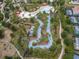 Overhead view of the community lazy river winding through lush landscaping and resort-style amenities at 1415 Oak Marsh St, Davenport, FL 33837