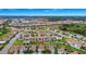 Aerial shot of a neighborhood featuring tile roofs, sidewalks, and green spaces, with solar panels at 1415 Oak Marsh St, Davenport, FL 33837