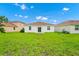 Expansive backyard featuring verdant green grass, and new construction homes creating an appealing outdoor space at 1415 Oak Marsh St, Davenport, FL 33837
