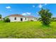 Lush backyard featuring green grass, a tree, and new construction homes creating a great outdoor space at 1415 Oak Marsh St, Davenport, FL 33837
