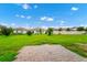 Spacious backyard with green grass, a patio, and new construction homes creating a great outdoor space at 1415 Oak Marsh St, Davenport, FL 33837