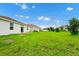 Broad backyard showcasing green grass, and new construction homes creating an appealing outdoor space at 1415 Oak Marsh St, Davenport, FL 33837