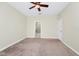 Spacious bedroom featuring neutral carpet, a ceiling fan and an ensuite bathroom at 1415 Oak Marsh St, Davenport, FL 33837