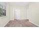 A well-lit bedroom boasting neutral walls, soft carpeting, and a closet with bi-fold doors at 1415 Oak Marsh St, Davenport, FL 33837
