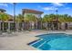 Elegant community center with a pool and inviting entryway, surrounded by lush palm trees at 1415 Oak Marsh St, Davenport, FL 33837