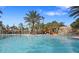 Inviting community pool with a water slide, palm trees, and a relaxing resort-style atmosphere at 1415 Oak Marsh St, Davenport, FL 33837