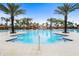 Stunning community pool area featuring palm trees, a water slide, and ample seating for residents at 1415 Oak Marsh St, Davenport, FL 33837