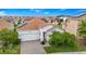 A charming home features a clay tile roof and solar panels at 1415 Oak Marsh St, Davenport, FL 33837