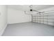 A spacious two car garage featuring an automatic door opener and ample room for vehicles and storage at 1415 Oak Marsh St, Davenport, FL 33837