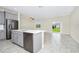 Kitchen shows stainless dishwasher, island sink, and living area sliding glass doors at 1415 Oak Marsh St, Davenport, FL 33837