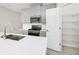 Modern kitchen featuring stainless steel appliances, gray cabinetry, white countertops and a walk-in pantry at 1415 Oak Marsh St, Davenport, FL 33837