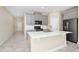 Kitchen area with a white countertop island and stainless steel appliances at 1415 Oak Marsh St, Davenport, FL 33837