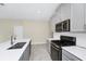 Bright kitchen with stainless steel appliances, subway tile backsplash, gray cabinets, and a large island at 1415 Oak Marsh St, Davenport, FL 33837