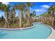 Picturesque lazy river meandering through tropical landscaping, offering a serene and relaxing experience at 1415 Oak Marsh St, Davenport, FL 33837