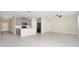 Open-concept living space with tile floors, gray cabinetry, and stainless steel appliances at 1415 Oak Marsh St, Davenport, FL 33837