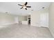 The open-concept area showcases a ceiling fan and neutral wall paint at 1415 Oak Marsh St, Davenport, FL 33837