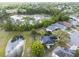 Aerial view of the home with ponds and lush green surroundings in a peaceful neighborhood setting at 14620 Old Forest Ct, Orlando, FL 32826