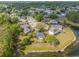 Stunning aerial view of the property showcasing its location near a serene lake and lush green surroundings at 14620 Old Forest Ct, Orlando, FL 32826