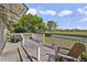Outdoor deck with a grill, relaxing Adirondack chairs, and a view of the backyard and greenery at 14620 Old Forest Ct, Orlando, FL 32826