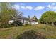 Spacious backyard with a well-maintained lawn, wooden deck, and mature trees, offering a peaceful retreat at 14620 Old Forest Ct, Orlando, FL 32826