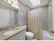 Light and airy bathroom with a shower-tub combo, skylight and neutral tile at 14620 Old Forest Ct, Orlando, FL 32826