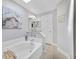 Bright bathroom featuring a soaking tub with stylish fixtures and a calming, neutral color palette at 14620 Old Forest Ct, Orlando, FL 32826