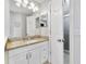 Granite countertop bathroom vanity with white cabinetry and brushed nickel hardware, next to glass shower at 14620 Old Forest Ct, Orlando, FL 32826