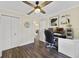 Well-lit home office with a ceiling fan and hardwood floors, featuring a large desk space at 14620 Old Forest Ct, Orlando, FL 32826