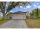 Charming home featuring a well-manicured lawn, a spacious driveway, and an attached two-car garage at 14620 Old Forest Ct, Orlando, FL 32826
