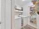 Organized laundry room features a full-size washer and dryer, with shelving and a rug at 14620 Old Forest Ct, Orlando, FL 32826