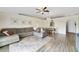 Open-concept living room and dining area with wood-look floors and modern decor, perfect for entertaining at 14620 Old Forest Ct, Orlando, FL 32826