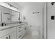 Bright bathroom features a granite countertop vanity, modern fixtures, and a glass enclosed shower at 1475 James St, New Smyrna Beach, FL 32168