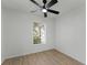 Bedroom features wood-look floors, a ceiling fan, and a window with natural light at 1475 James St, New Smyrna Beach, FL 32168