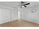 Spacious bedroom featuring wood floors, a ceiling fan, an octagon window and double closets at 1475 James St, New Smyrna Beach, FL 32168