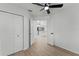 Bedroom featuring wood-look floors and a view into the kitchen and living space at 1475 James St, New Smyrna Beach, FL 32168