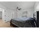 Cozy bedroom with wood floors, a ceiling fan, and a view of the outdoors through a window at 1475 James St, New Smyrna Beach, FL 32168