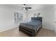 Comfortable bedroom with wood floors and large windows offering pleasant views of the outdoors at 1475 James St, New Smyrna Beach, FL 32168