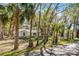 Home nestled among trees with lots of shade and a driveway at 1475 James St, New Smyrna Beach, FL 32168