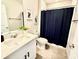 Bathroom featuring a modern vanity with quartz countertop, framed art, and dark shower curtain at 1513 Congaree St # 1513, Davenport, FL 33837